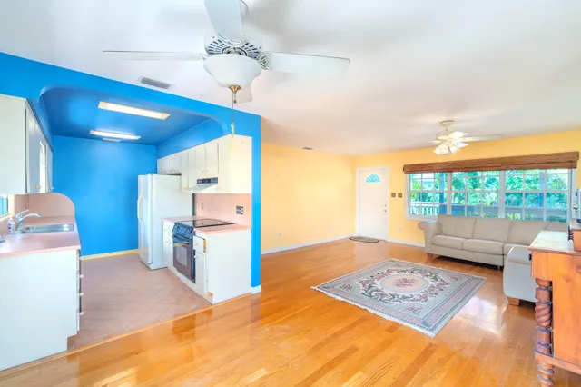 a kitchen with stainless steel appliances granite countertop a sink a stove and a refrigerator