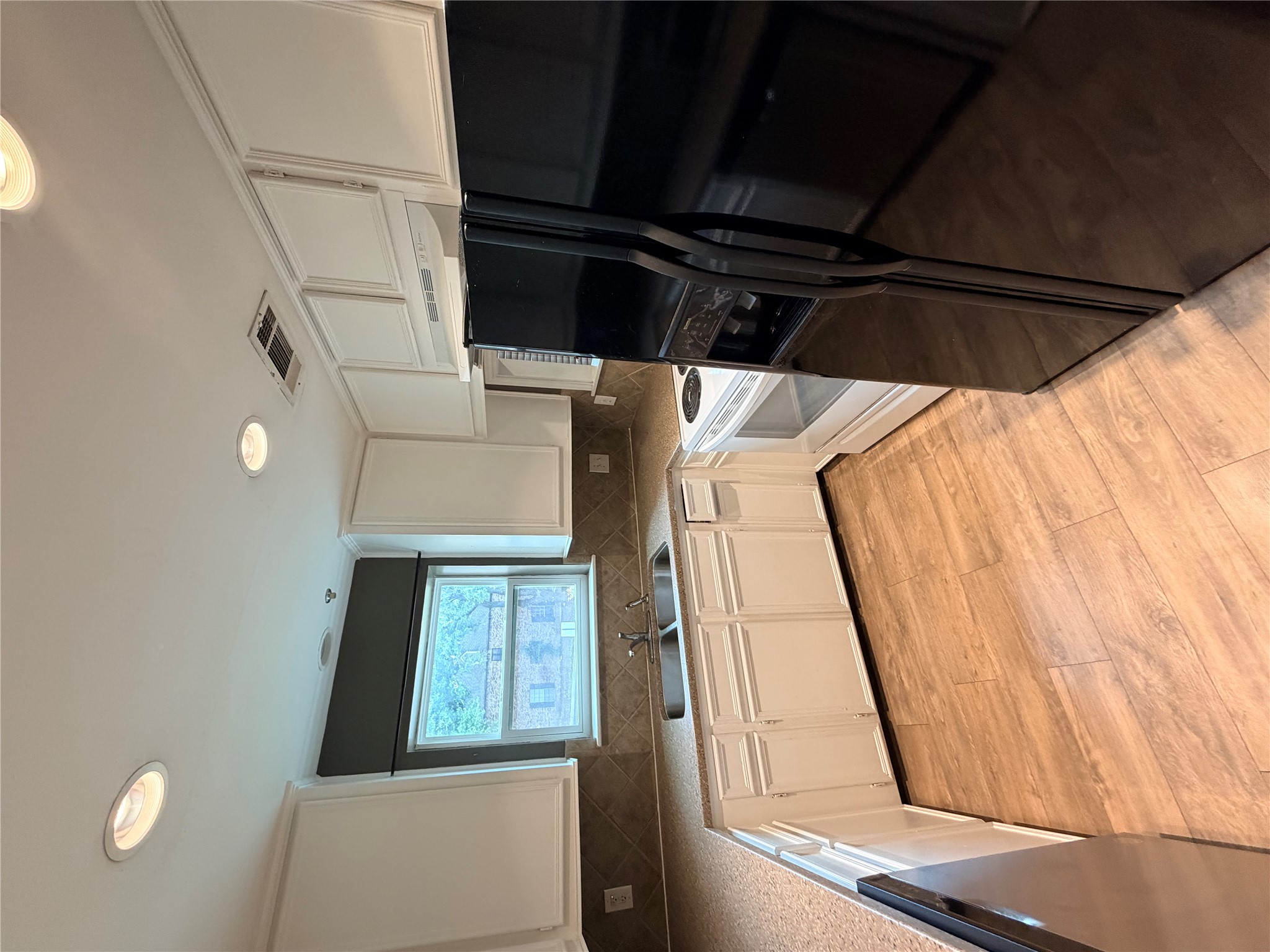 6600 Valleyside Road, Unit D20 Austin, TX 78731 - Photo 2 of 14 A well-equipped culinary space awaits with extensive counter space and practical wood flooring.