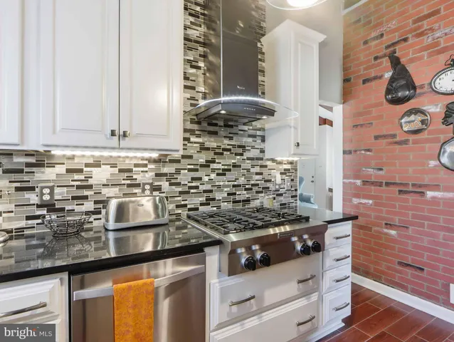 a kitchen with a stove and a cabinets