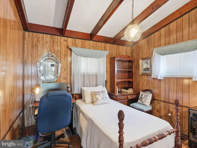 a bedroom with a bed and flat screen tv