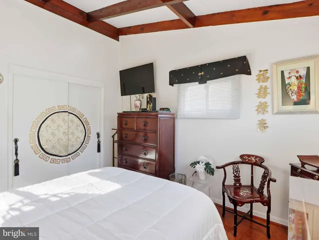 a bedroom with a bed and a lamp on table