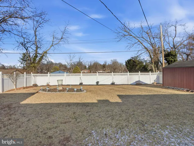 a front view of house with yard and trees in the background