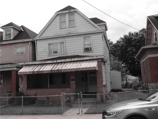 a front view of a house with parking