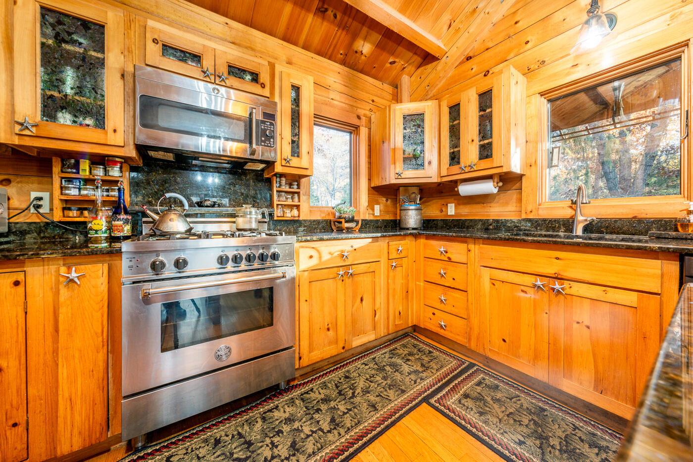 119 Valley Bars Road Bourne, MA 02532 - Photo 12 of 46 a kitchen with stainless steel appliances granite countertop a stove a sink and a microwave