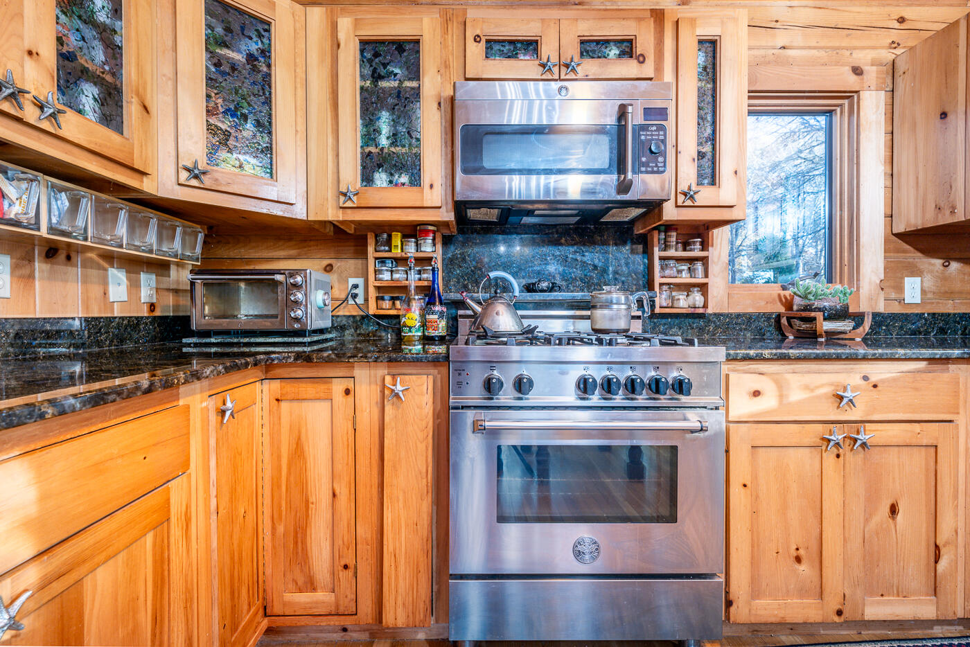119 Valley Bars Road Bourne, MA 02532 - Photo 13 of 46 a kitchen with stainless steel appliances granite countertop a stove a sink and a microwave