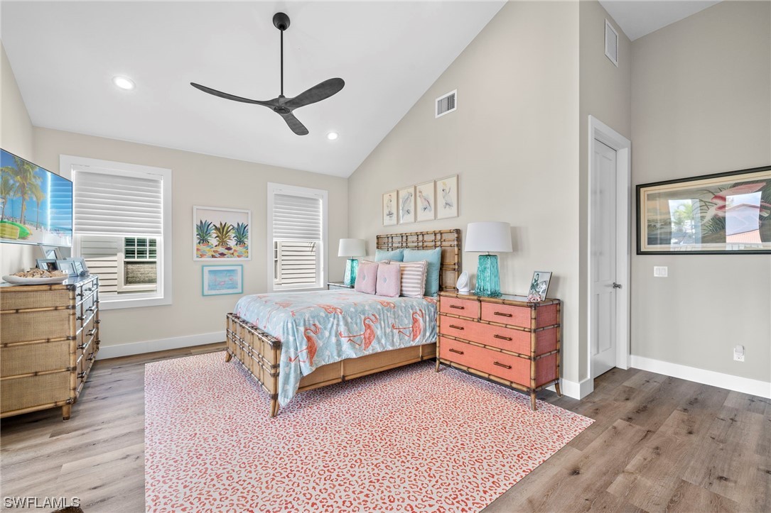 11517 Wightman Lane Captiva, FL 33924 - Photo 12 of 48 a bedroom with a large bed and dresser