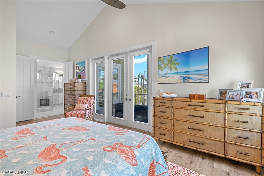 11517 Wightman Lane Captiva, FL 33924 - Photo 13 of 48 a bedroom with a bed and a dresser in it