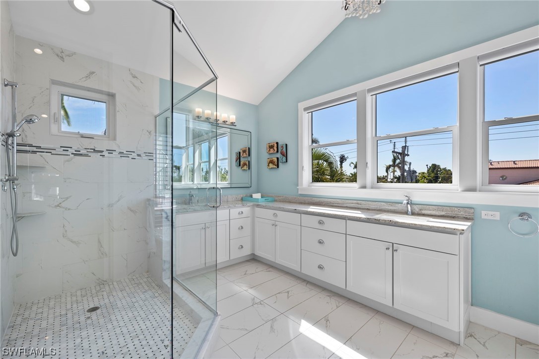 11517 Wightman Lane Captiva, FL 33924 - Photo 15 of 48 a bathroom with a granite countertop sink mirror and a bathtub