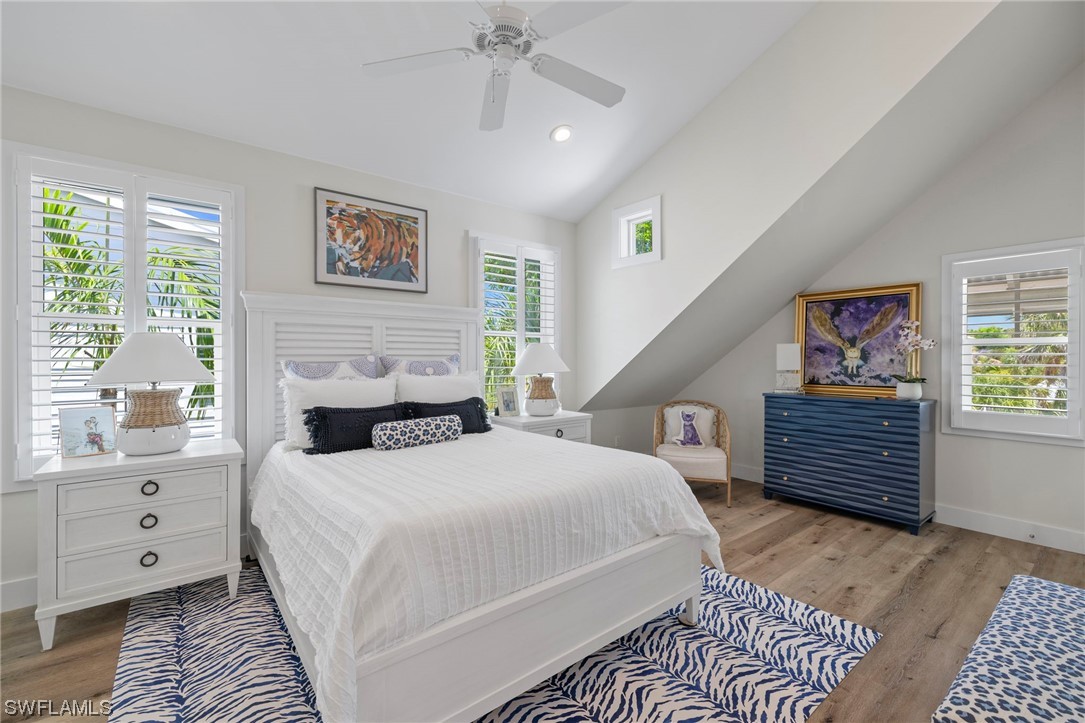 11517 Wightman Lane Captiva, FL 33924 - Photo 17 of 48 a bedroom with a large bed and a window