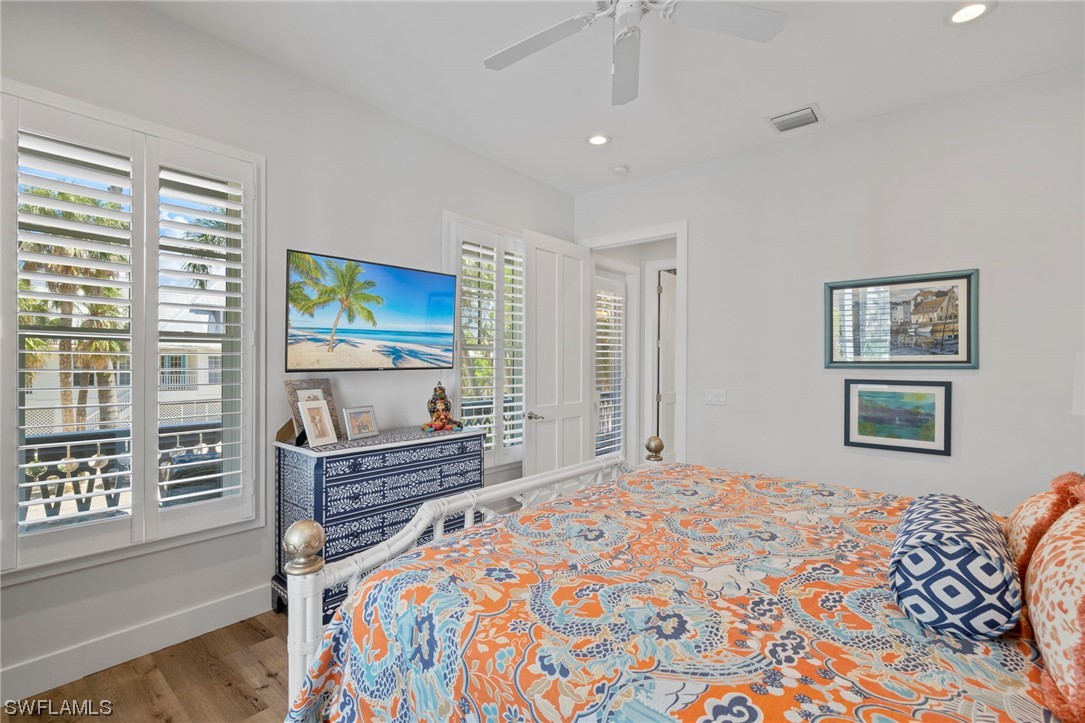 11517 Wightman Lane Captiva, FL 33924 - Photo 24 of 48 a bedroom with a bed and a dresser