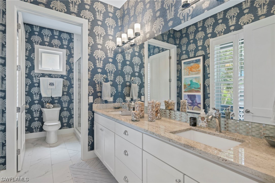 11517 Wightman Lane Captiva, FL 33924 - Photo 25 of 48 a bathroom with a granite countertop sink mirror and toilet