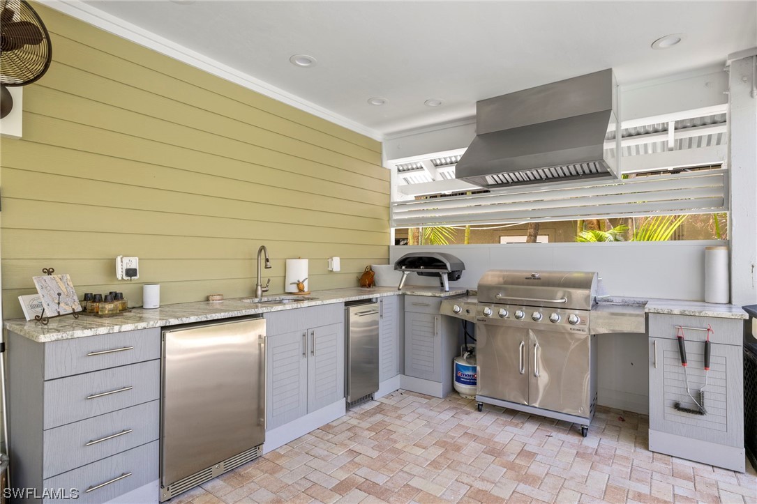 11517 Wightman Lane Captiva, FL 33924 - Photo 31 of 48 a kitchen with stainless steel appliances granite countertop a sink and a stove