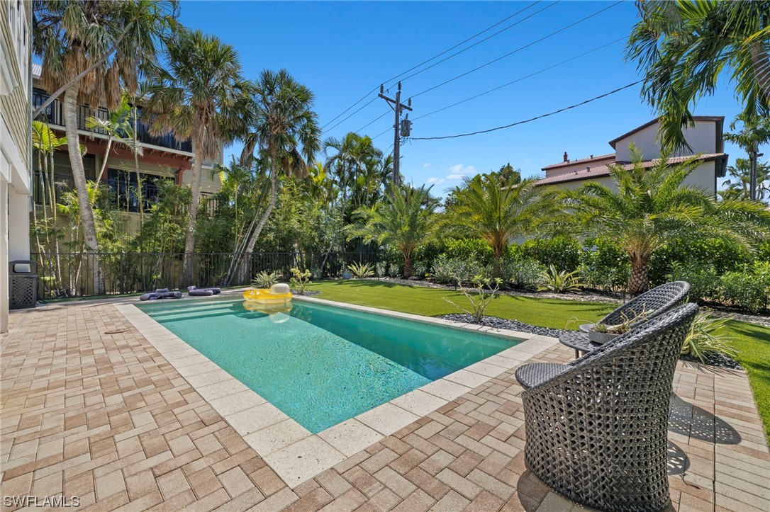 11517 Wightman Lane Captiva, FL 33924 - Photo 41 of 48 a view of a swimming pool with a patio and a yard
