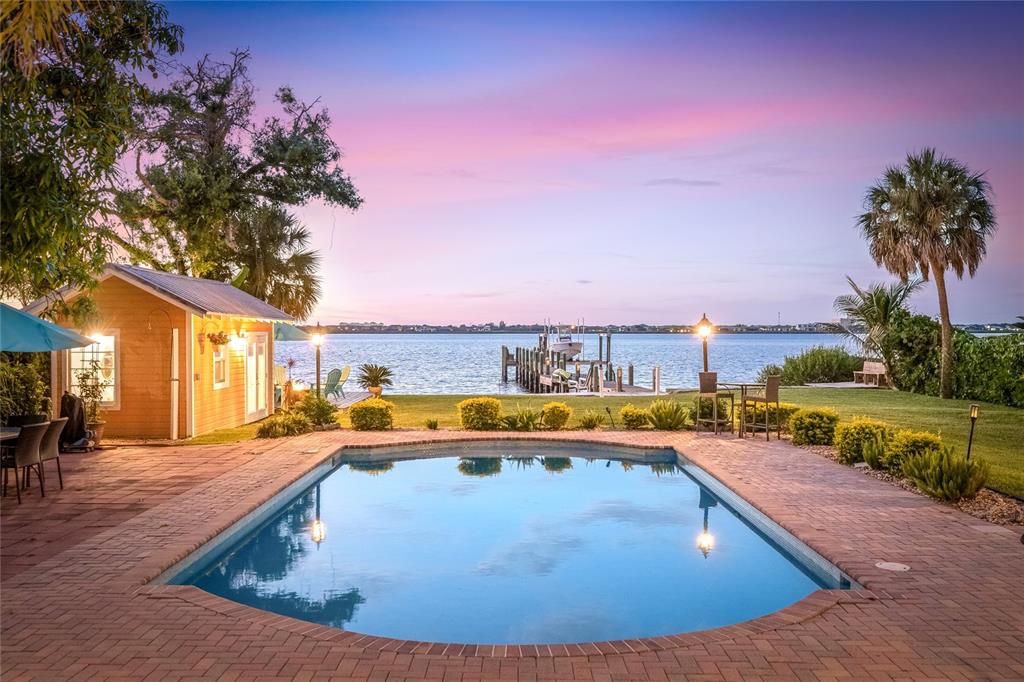 19007 Scallop Loop, Unit 204 Lakewood Ranch, FL 34211 - Photo 52 of 57 a view of a swimming pool with an outdoor seating and a yard
