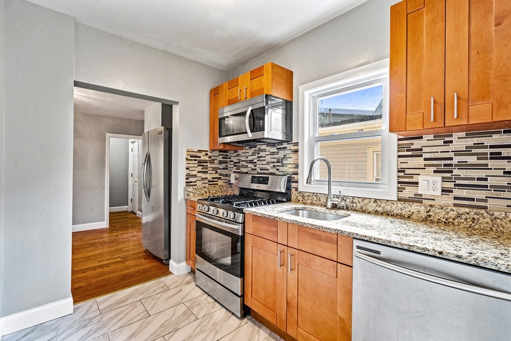 a kitchen with stainless steel appliances granite countertop a stove and a sink