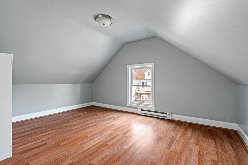 79 Derby Street, Unit 2 Somerville, MA 02145 - Photo 11 of 18 an empty room with wooden floor and windows