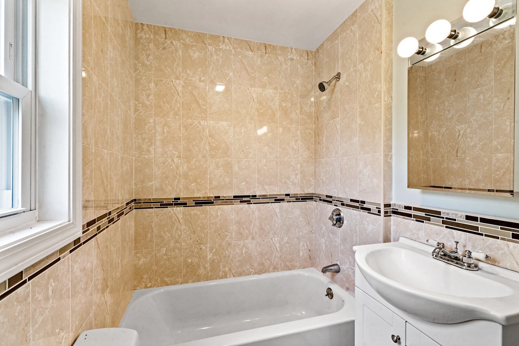 79 Derby Street, Unit 2 Somerville, MA 02145 - Photo 13 of 18 a bathroom with a sink and a bathtub
