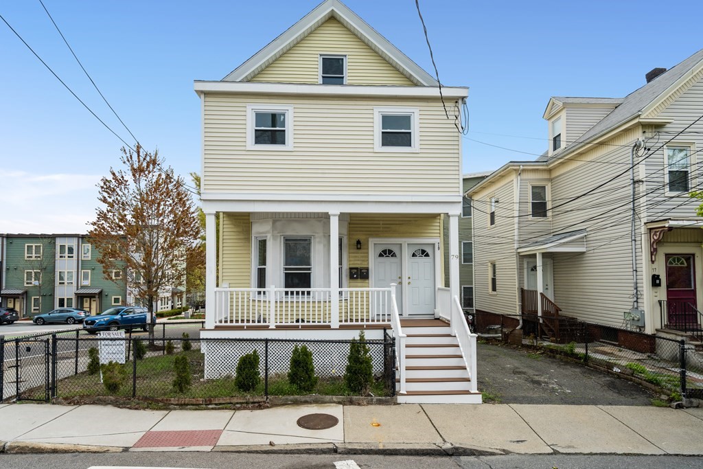 79 Derby Street, Unit 2 Somerville, MA 02145 - Photo 16 of 18 a front view of a house with a yard