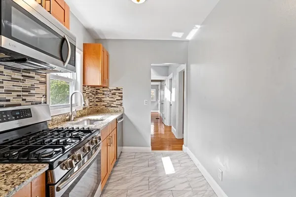 a kitchen with stainless steel appliances a stove and a refrigerator