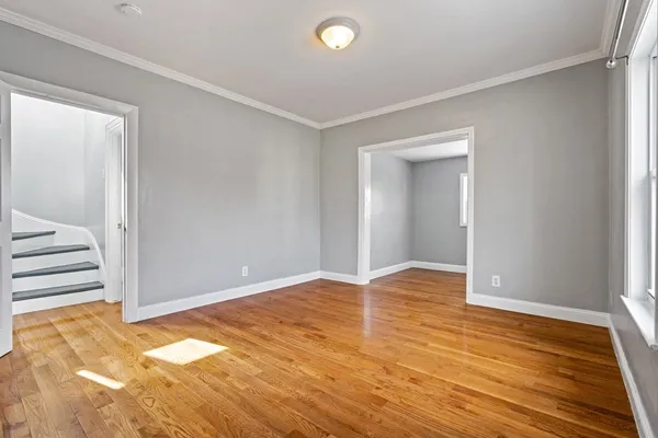 an empty room with wooden floor and closet