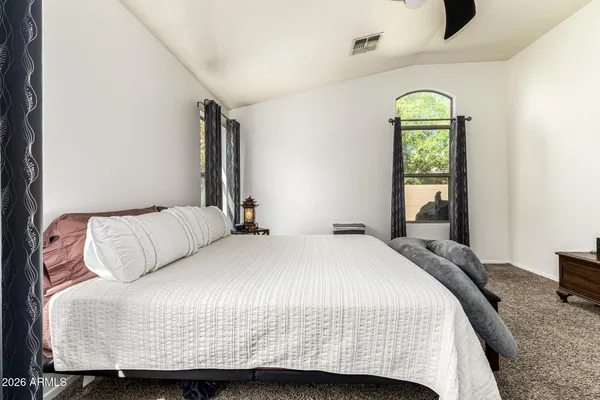 a bedroom with a bed and a window