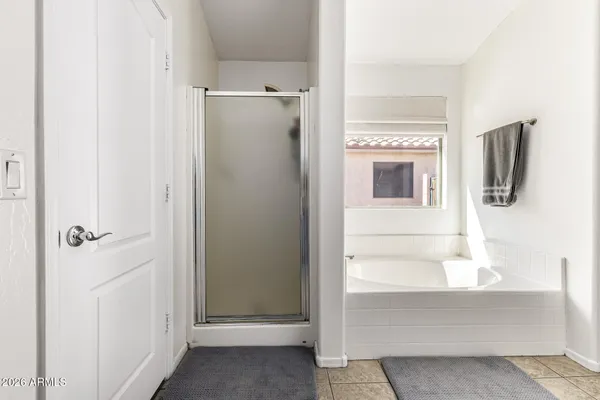 a bathroom with a walk in closet and a fireplace