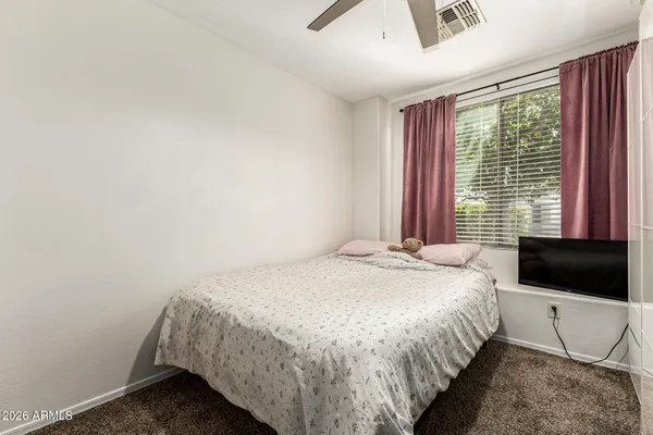 a bedroom with a bed and a television