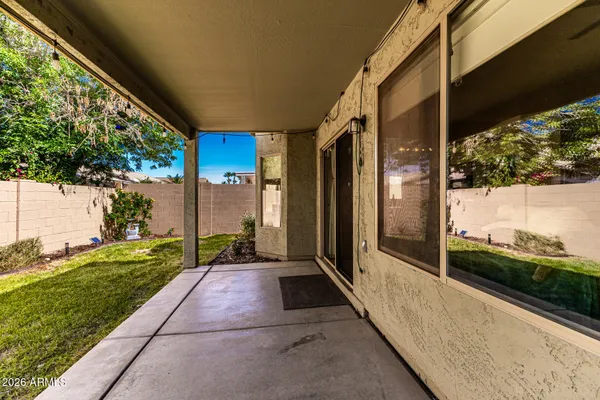 a porch with a table and chairs