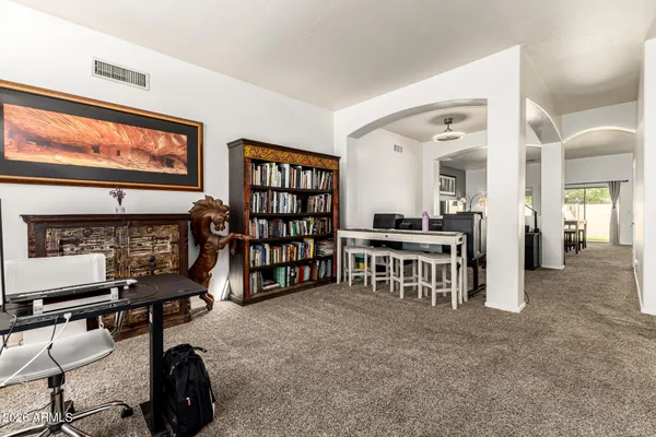 a room with furniture and a bookshelf