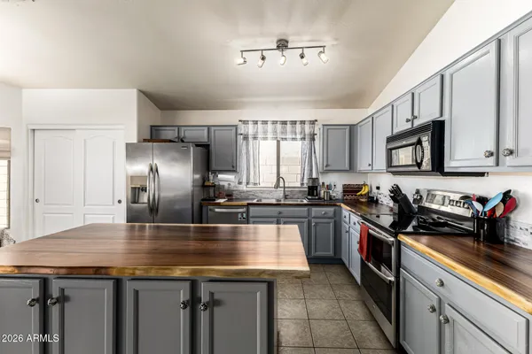 a kitchen with a stove a sink and a refrigerator