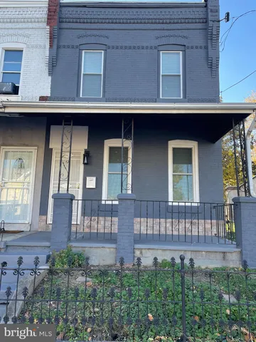 a view of a house with large windows and a table and chairs