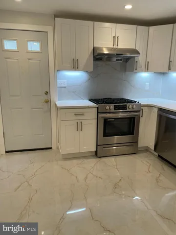 a kitchen with granite countertop a stove and a sink