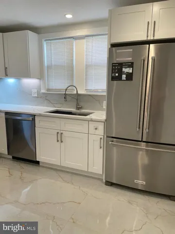 a kitchen with appliances cabinets and a sink