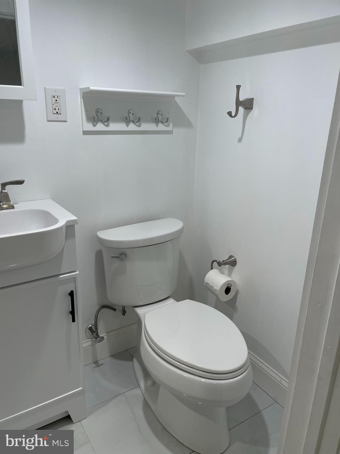 346 Parker Street Chester, PA 19013 - Photo 23 of 32 a white toilet sitting next to a bathroom sink