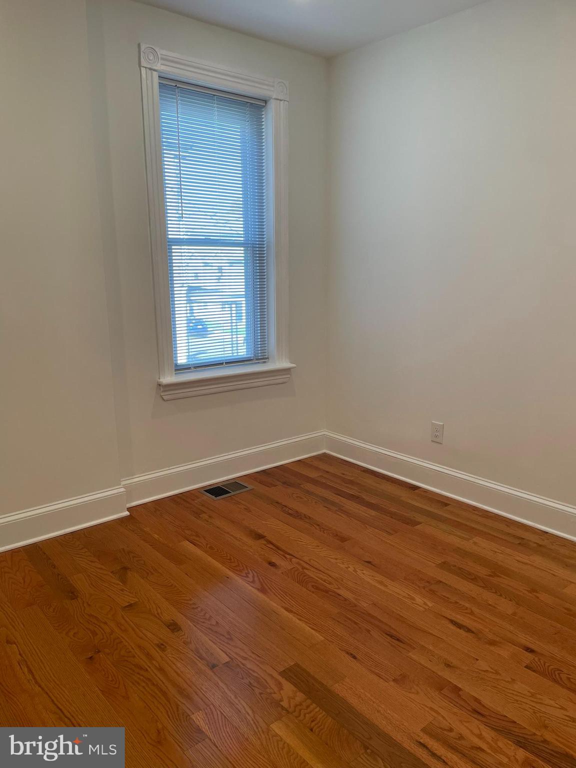 346 Parker Street Chester, PA 19013 - Photo 32 of 32 an empty room with wooden floor and windows
