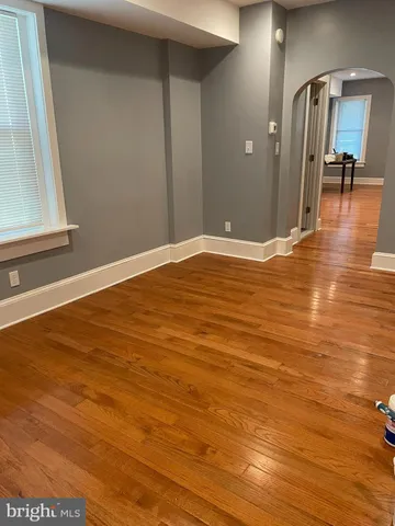 a view of a room with wooden floor and furniture