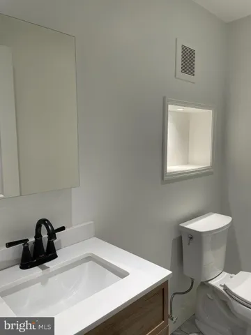 a bathroom with a sink toilet and vanity