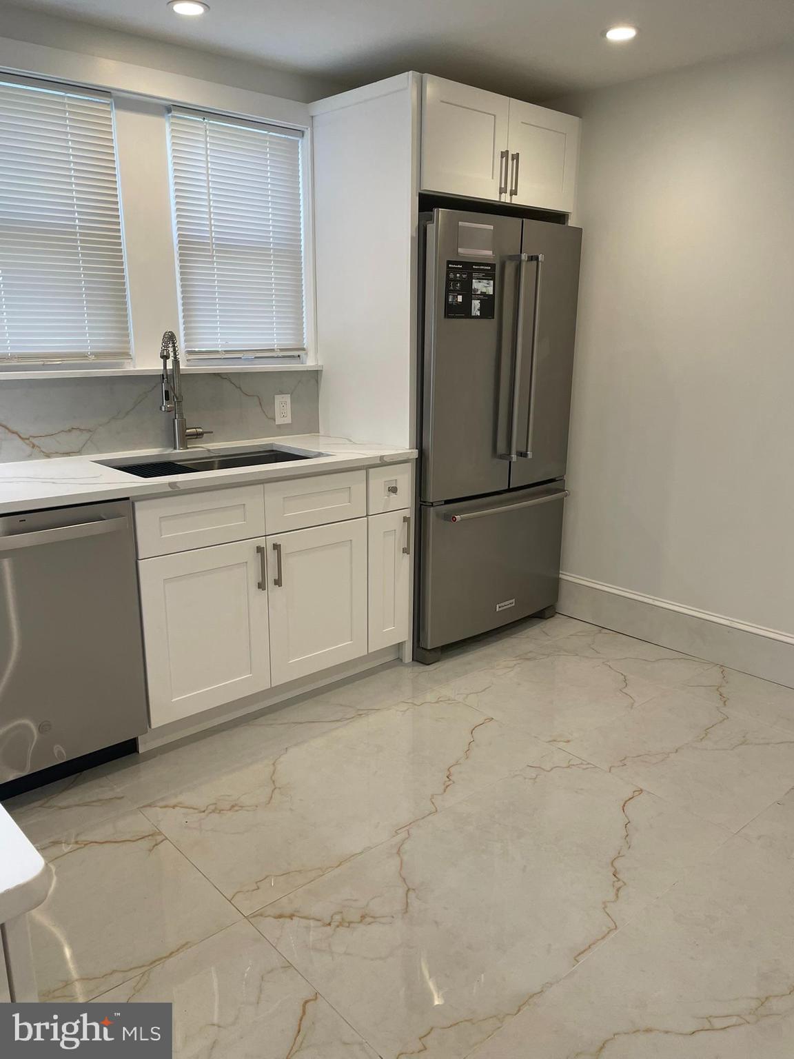 346 Parker Street Chester, PA 19013 - Photo 10 of 32 a kitchen with stainless steel appliances granite countertop a refrigerator and a sink