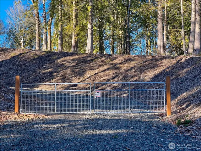 a view of a backyard with wooden fence