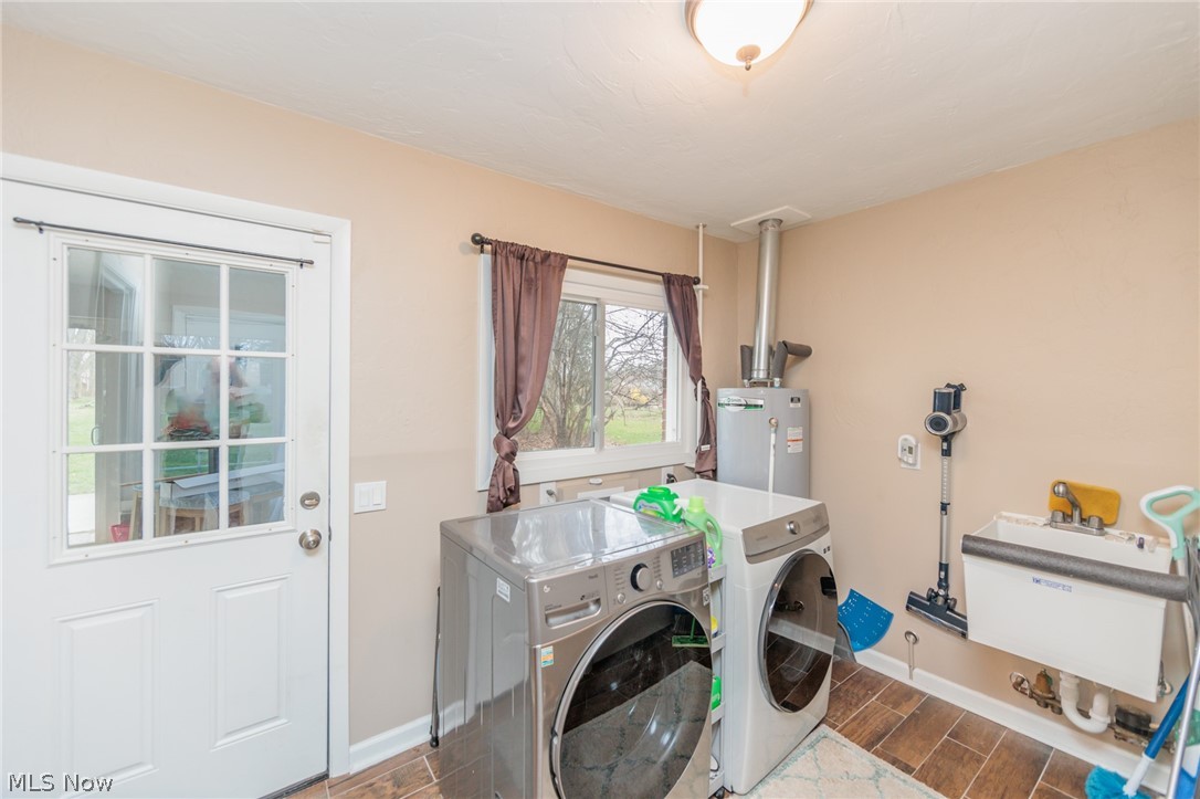 490 Trebisky Road Cleveland, OH 44143 - Photo 22 of 49 Laundry area with sink, water heater, dark wood-type flooring, and independent washer and dryer