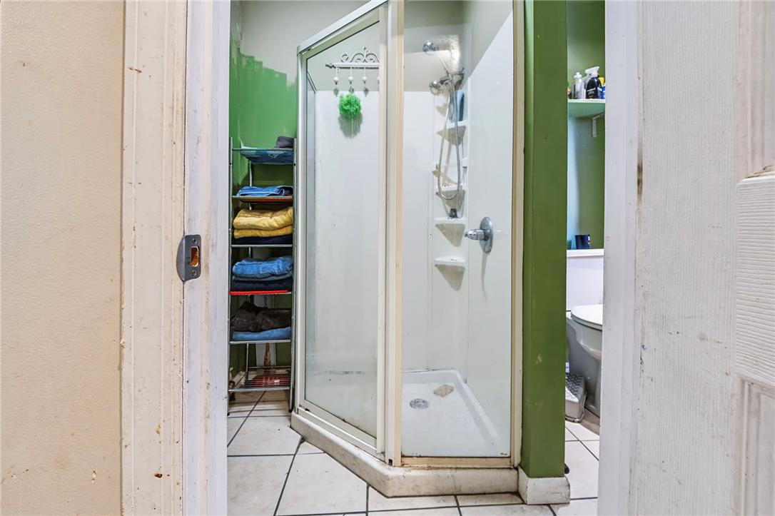 1030 Monocacy Street Bethlehem, PA 18018 - Photo 12 of 34 Tiled flooring anchors this functional bathroom featuring a corner glass shower enclosure.