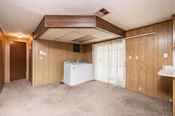 a view of a utility room with closet and windows