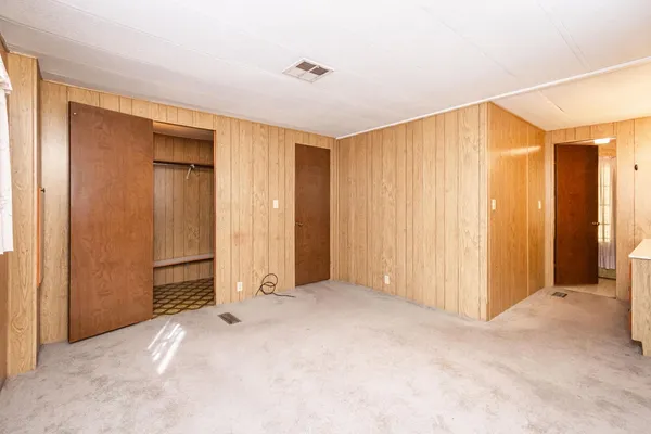 a view of a livingroom with an empty space and a window
