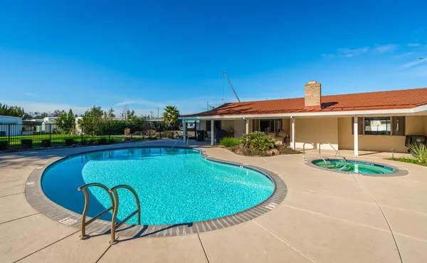 a view of a swimming pool with a patio
