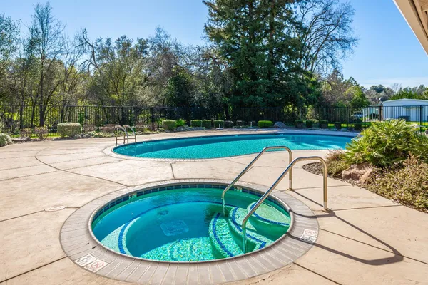 a view of a swimming pool with a yard