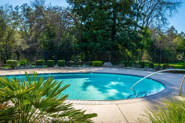 a view of a swimming pool with a patio