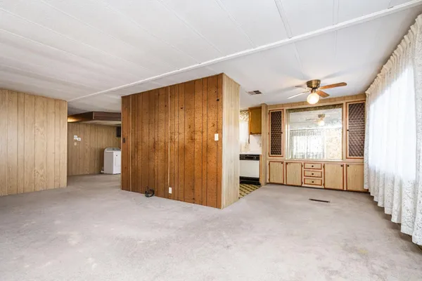 a view of empty room with wooden walls