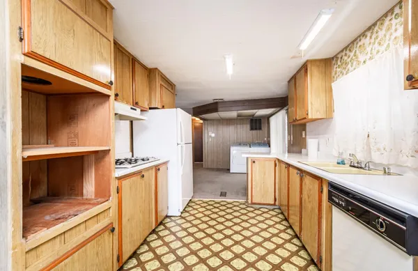 a kitchen with a sink stove and refrigerator