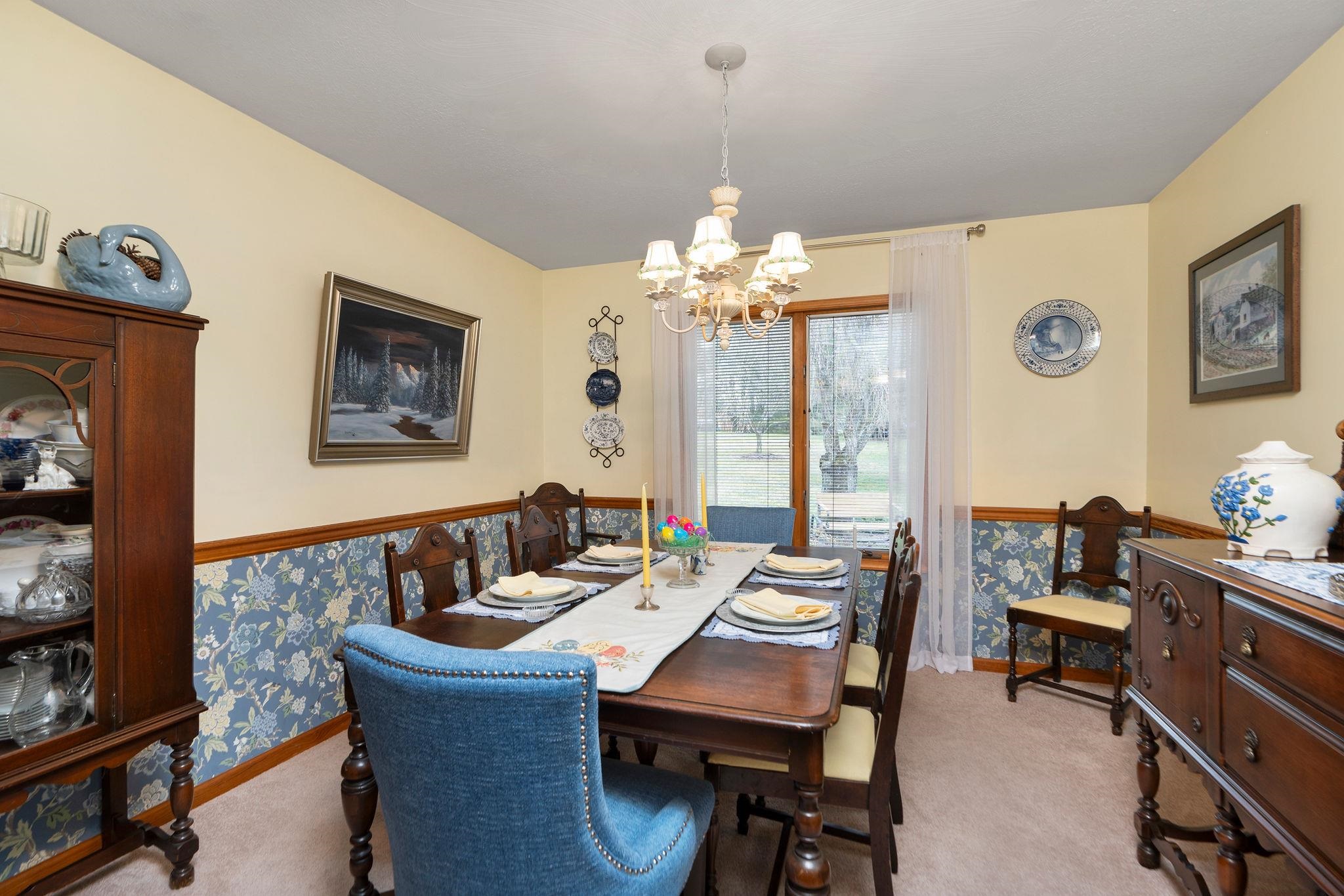 53 Fort River Road Verona, VA 24482 - Photo 15 of 75 a dining room with wooden floor a chandelier a wooden table and chairs