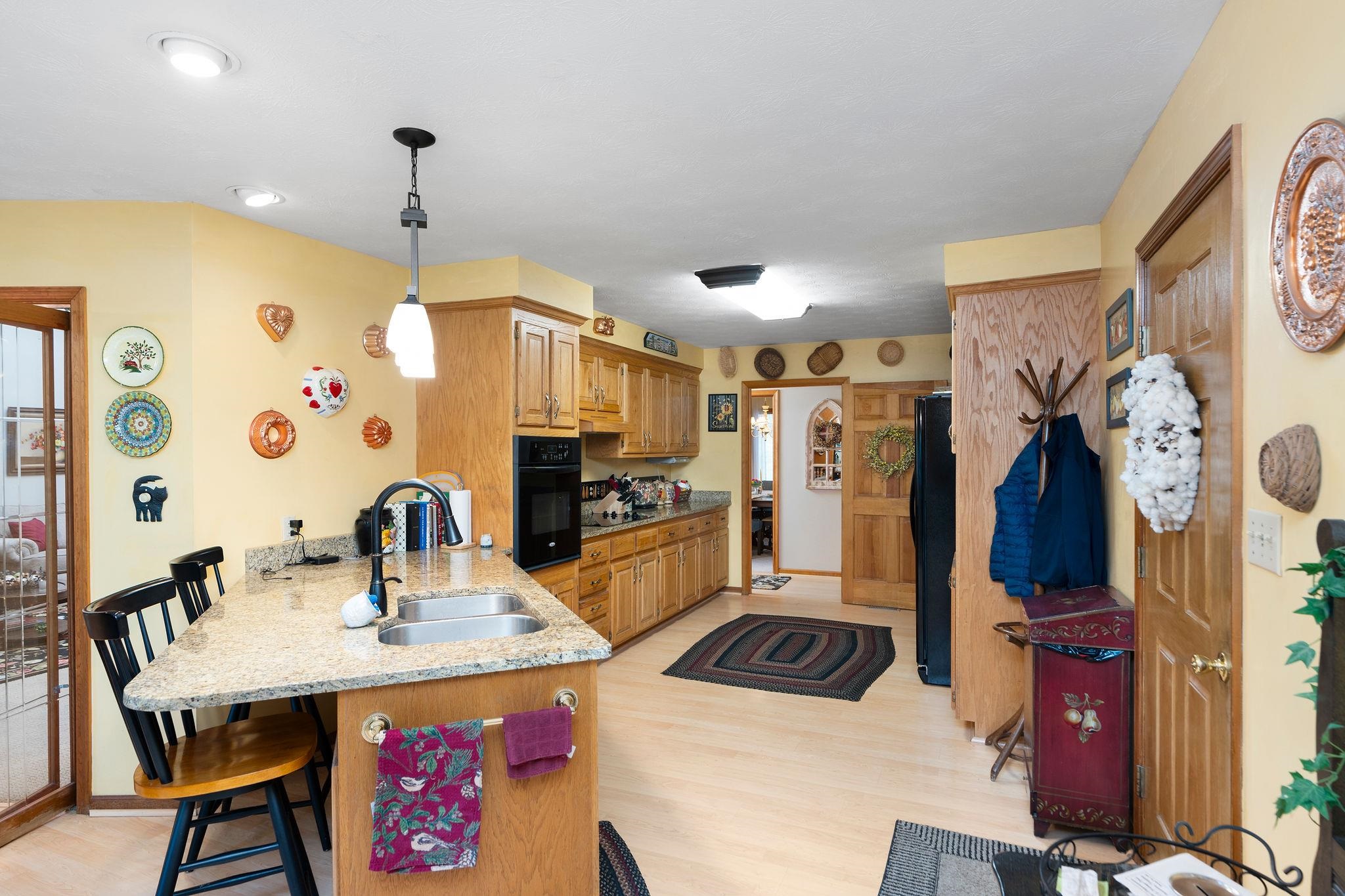 53 Fort River Road Verona, VA 24482 - Photo 17 of 75 a kitchen with stainless steel appliances a sink a stove a refrigerator a dining table and chairs with the wooden floor